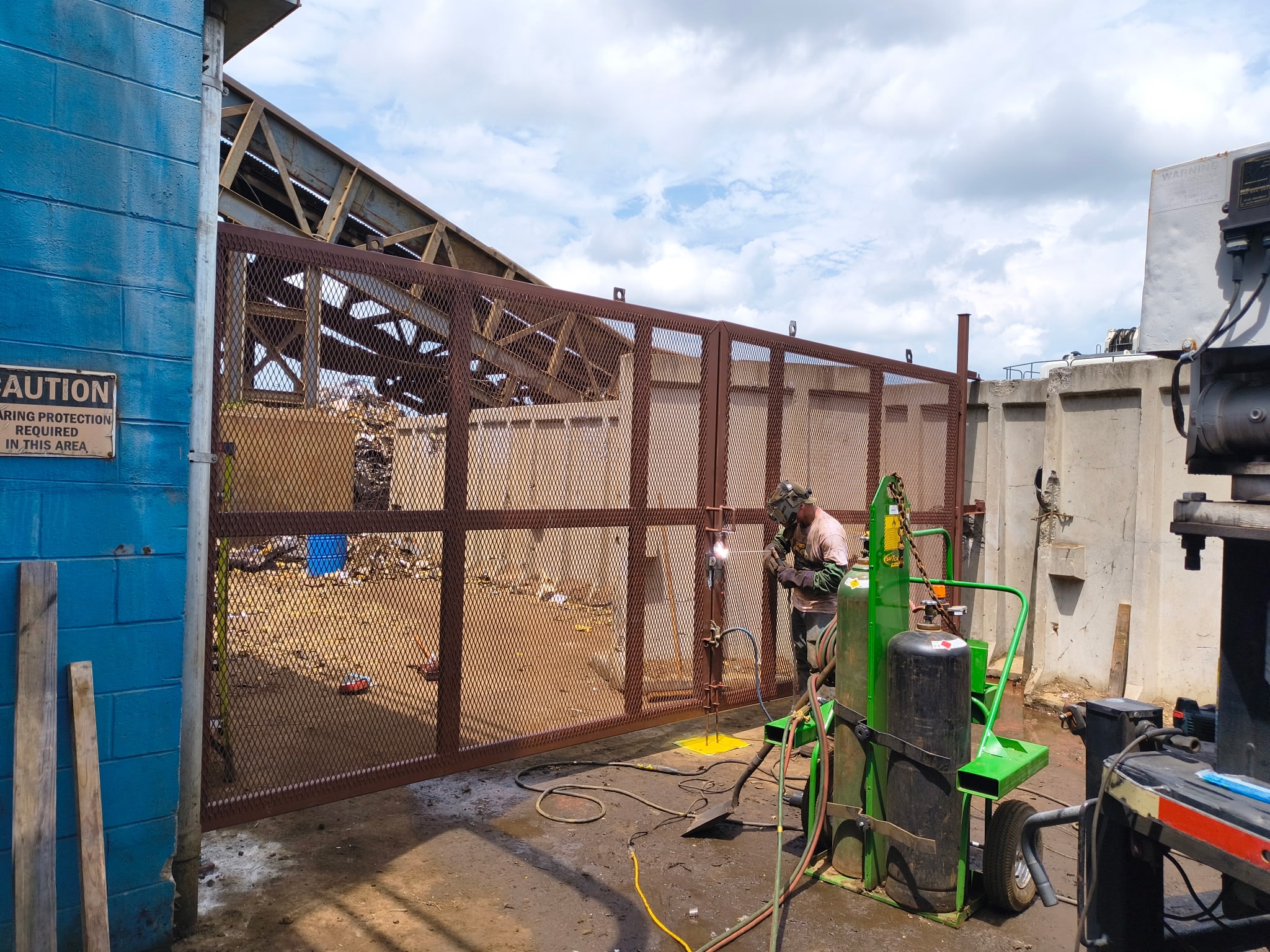 Custom fabricated gate with welder on site
